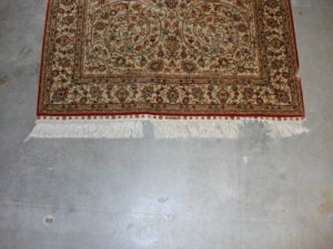 damaged area rug with frayed fringe